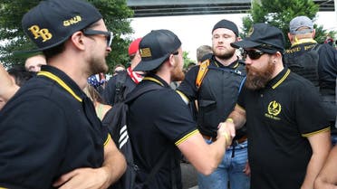 Members of the alt-right group, Proud Boys, shake hands during the End Domestic Terrorism rally on August 17, 2019 in Portland, Oregon. (AFP)