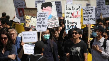 Protesters hold up placards as they gather in central London to attend a march organised by StandwithHK and D4HK in support of Pro-democracy protests in Hong Kong, on August 17, 2019. (AFP)