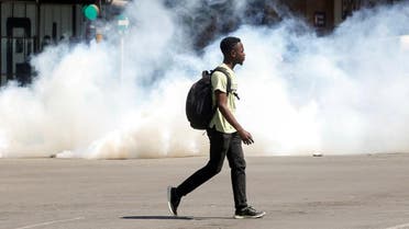 A man walks past clouds of teargas during clashes after police banned planned protests over austerity and rising living costs. (Reuters)
