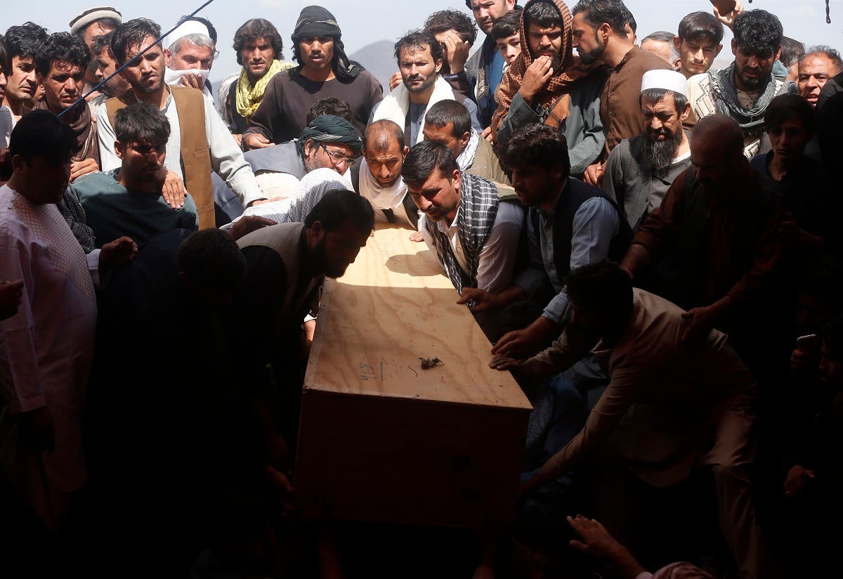 Afghans carry the body of a victim of the Dubai City wedding hall bombing during a mass funeral in Kabul, Afghanistan, on Aug.18, 2019. (AP)