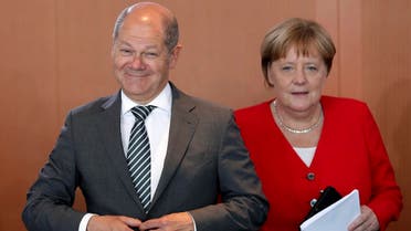 German Finance Minister Olaf Scholz (left), and German Chancellor Angela Merkel (right), arrive for the weekly cabinet meeting at the Chancellery in Berlin, Germany, on June 19, 2019. (AP)