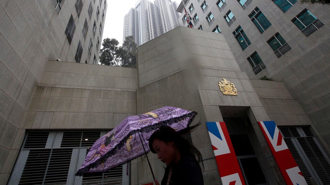 A woman walks past the British Consulate where a Union Flag is lowered to half mast in Hong Kong Tuesday, April. 9, 2013 in honor of former British Prime Minister Margaret Thatcher. (AP)