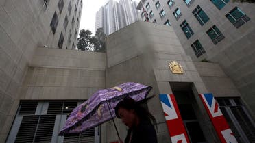 A woman walks past the British Consulate where a Union Flag is lowered to half mast in Hong Kong Tuesday, April. 9, 2013 in honor of former British Prime Minister Margaret Thatcher.  (AP)