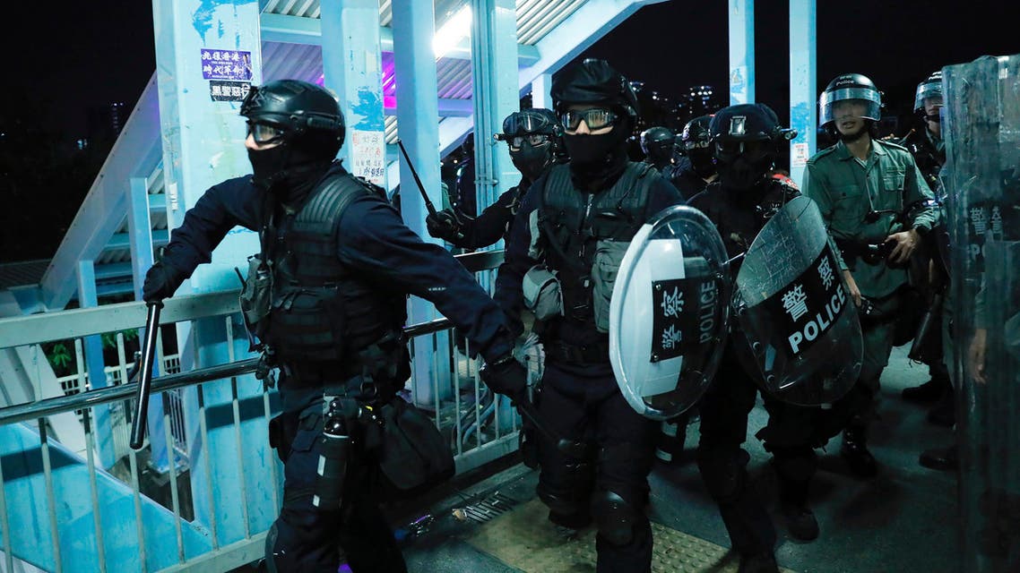 Riot police gather outside the Yuen Long MTR station during a protest in Hong Kong, Wednesday, Aug. 21, 2019. (AP)