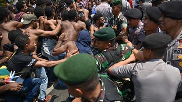 Papuan students taking part in a rally push toward a line of police and military blocking them in front of the army's headquarters in Jakarta on August 22, 2019. (AFP)