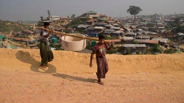 Rohingya refugees carry a hume pipe for construction of toilets inside Balukhali refugee camp near Cox's Bazar, in Bangladesh. (AFP)