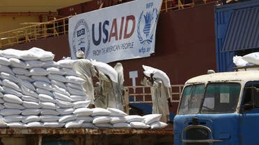 Sudanese dockers unload bags of sorgham (cereal) from one of two US ships carrying humanitarian aid supplies provided by the US development agency USAID, at Port Sudan on the red sea coast on June 5, 2018. The United States is the largest single donor to the world food program in Sudan and regularly distributes food aid to the East African country. This shipment will be distributed to over a million Sudanese who are in need of assistance. 