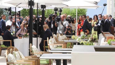 The press corps gather as US President Trump (R) sits to lunch with French President Macron (L), at the Hotel du Palais in Biarritz, on the first day of the annual G7 Summit on August 24, 2019. (AFP)