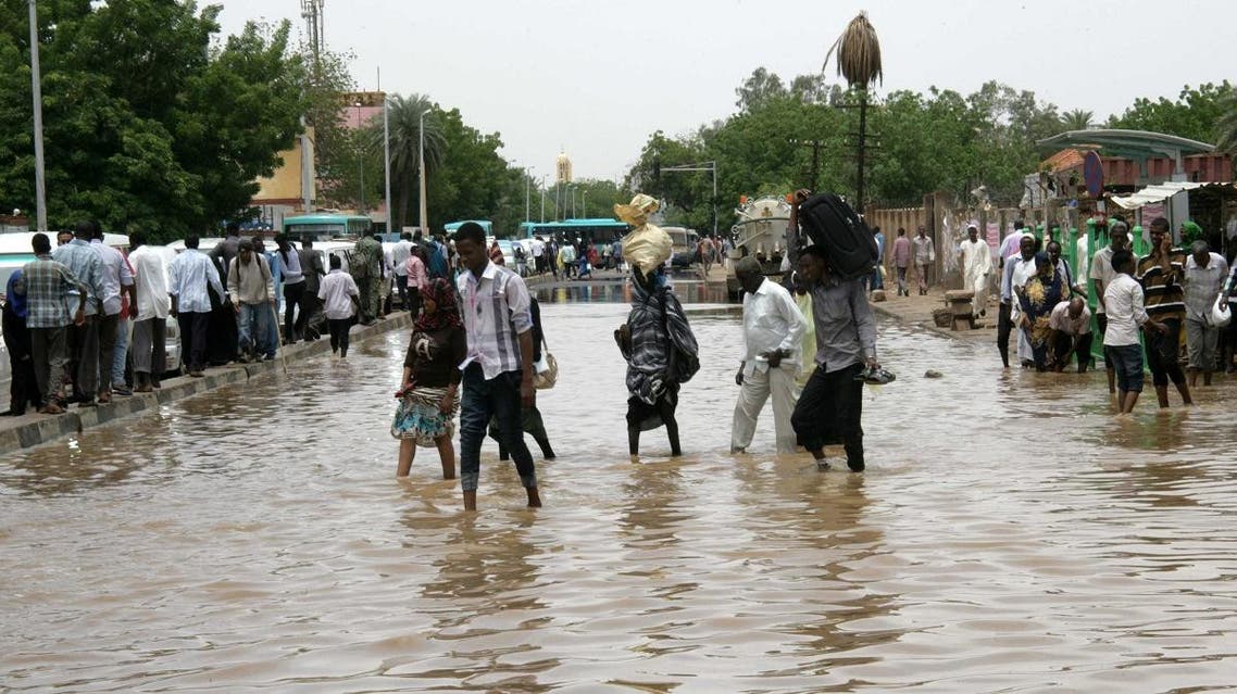 Sudanese cross a flooded street following heavy rain in the capital Khartoum. (File photo: AFP)