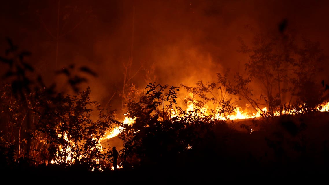 A fire burns in highway margins in the city of Porto Velho, Rondonia state, part of Brazil's Amazon, Sunday, Aug. 25, 2019. (AP)