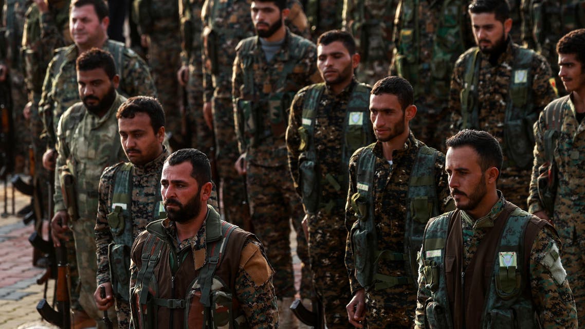 Syrian Kurdish members of the People's Protection Units (YPG) attend the funeral of a slain Kurdish commander in the northeastern city of Qamishli on December 6, 2018.