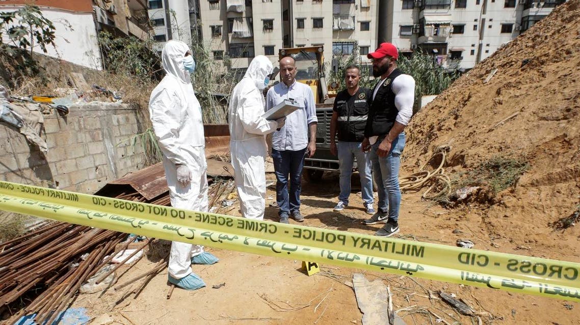 Forensic investigators of Lebanon’s military intelligence inspecting the scene where two drones came down in the vicinity of a media center for Hezbollah south of Beirut. (AFP)