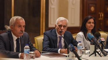 The removed mayor of Mardin Ahmet Turk (C) speaks during a foreign media conference alongside the removed mayor of Diyarbakir Adnan Selcuk Mizrakli (L) and the removed Kurdish mayor of Van Bedia Ozgokce Ertan (R) on August 29, 2019, in Istanbul. (AFP)