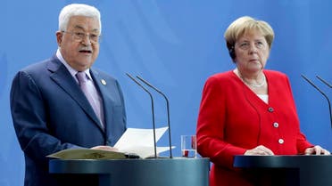 German Chancellor Angela Merkel, right, and Palestinian President Mahmoud Abbas, left, addresss the media during a joint statement prior to a meeting at the Chancellery in Berlin, Germany, Thursday, Aug. 29, 2019. (AP)