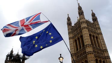 FILE PHOTO: Flags flutter outside the Houses of Parliament, ahead of a Brexit vote, in London, Britain March 13, 2019. REUTERS/Tom Jacobs/File Photo