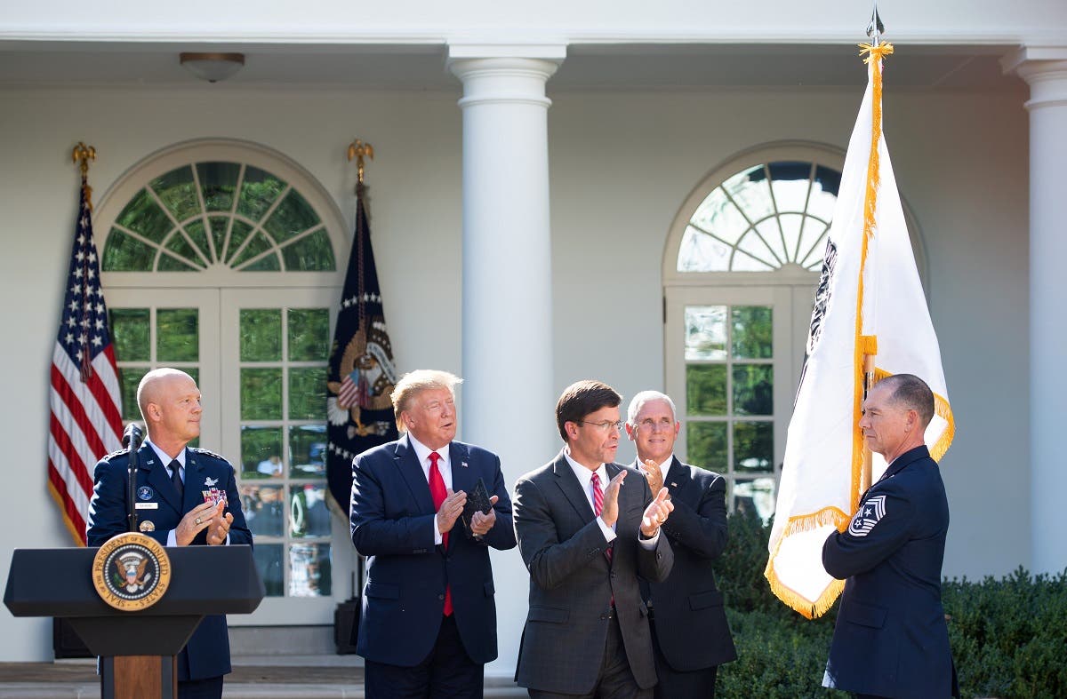A member of the US military holds the new US Space Command flag alongside (from L) US General John W. Raymond, President Donald Trump, Secretary of Defense Mark Esper and Vice President Mike Pence during an event establishing the US Space Command in the Rose Garden of the White House in Washington, DC, on August 29, 2019. (AFP)