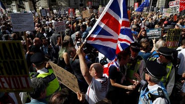 Brexit supporters surrounded by policemen hold British flags as anti Brexit protesters demonstrate during a rally outside Downing Street in London, Saturday, Aug. 31, 2019. (AP)