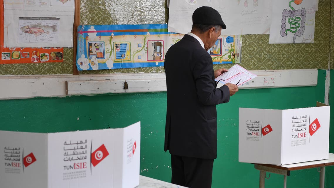 A Tunisian voter reads a list of candidates before casting his vote at a polling station in Tunis on May 6, 2018. Tunisia held its first free municipal elections Sunday as voters expressed frustration at the slow pace of change since the 2011 revolution in the cradle of the Arab Spring.