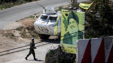 A U.N peacekeepers of the United Nations Interim Force in Lebanon (UNIFIL) walks near a poster depicting Lebanon's Hezbollah leader Hassan Nasrallah in Adaisseh. (AFP)