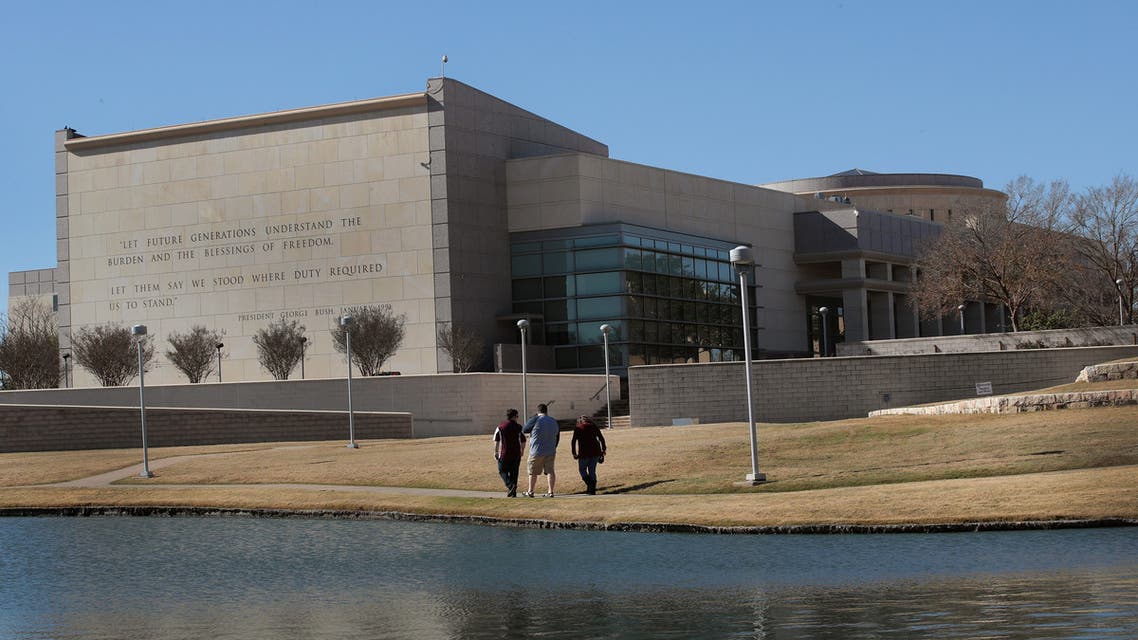 COLLEGE STATION, TX - DECEMBER 02: Visitors walk along a pond behind the George H.W. Bush Presidential Library Center on the campus of Texas A&M University on December 2, 2018 in College Station, Texas. Bush, who died on November 30, will be buried next to his wife Barbara near the library on Thursday. Scott Olson/Getty Images/AFP