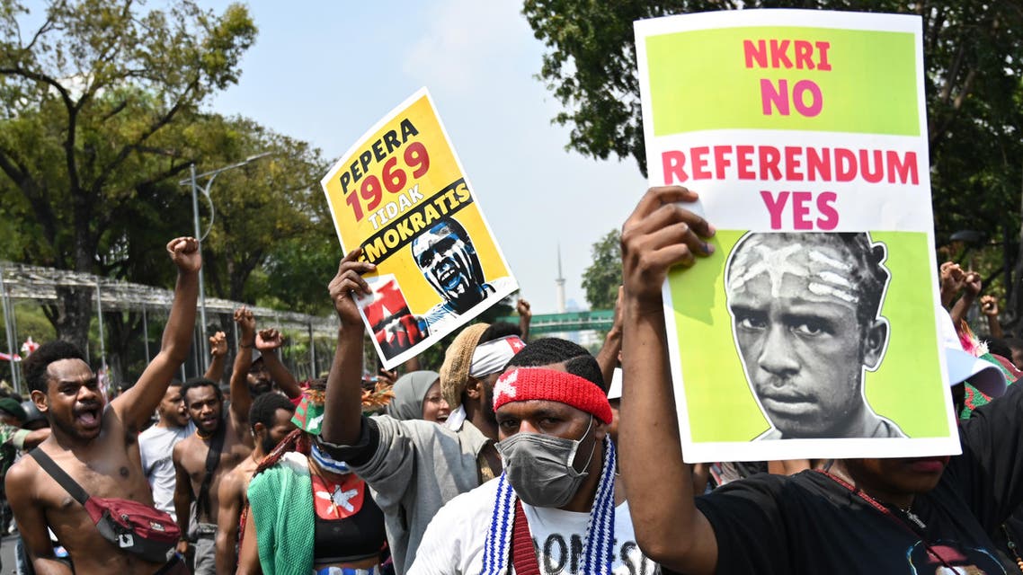 Papuan students display placards during a rally in front of the presidential palace in Jakarta on August 22, 2019, as riots and demonstrations have brought several cities in Indonesia's eastern province of Papua to a standstill this week. (AFP)
