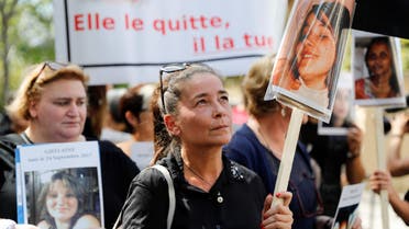 A woman holds the picture of a victim as she takes part in a protest march with other women holding placards denouncing the violence against women and called by the French association "Feminicides par compagnons ou ex" (Feminicides by companion or ex) on the opening day of the "Grenelle on domestic violence", in Paris (AFP)