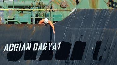 A crew member checks the new name of Iranian oil tanker Adrian Darya, formerly known as Grace 1, off the coast of Gibraltar. (File photo: Reuters)
