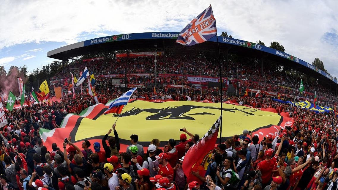 People hold a large banner with the logo of Scuderia Ferrari after the Italian Formula One Grand Prix at the Autodromo Nazionale circuit in Monza. (AFP)