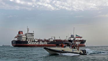 A speedboat of the Iran's Revolutionary Guard moves around a British-flagged oil tanker Stena Impero, which was seized on Friday by the Guard, in the Iranian port of Bandar Abbas, Sunday, July 21, 2019. (AP)
