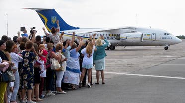 Friends and relatives waves as a plane carrying former prisoners lands on September 7, 2019 at Boryspil international airport in Kiev after a long-awaited exchange of prisoners between Moscow and Kiev, a day after Russian President said for the first time the "large-scale" prisoner exchange with Ukraine was being finalised. (AFP)