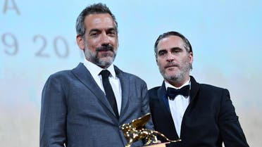 US director Todd Phillips (L), flanked by US actor Joaquin Phoenix, holds the Golden Lion award for Best Film he received for the movie "Joker" during the awards ceremony of the 76th Venice Film Festival on September 7, 2019 at Venice Lido. 