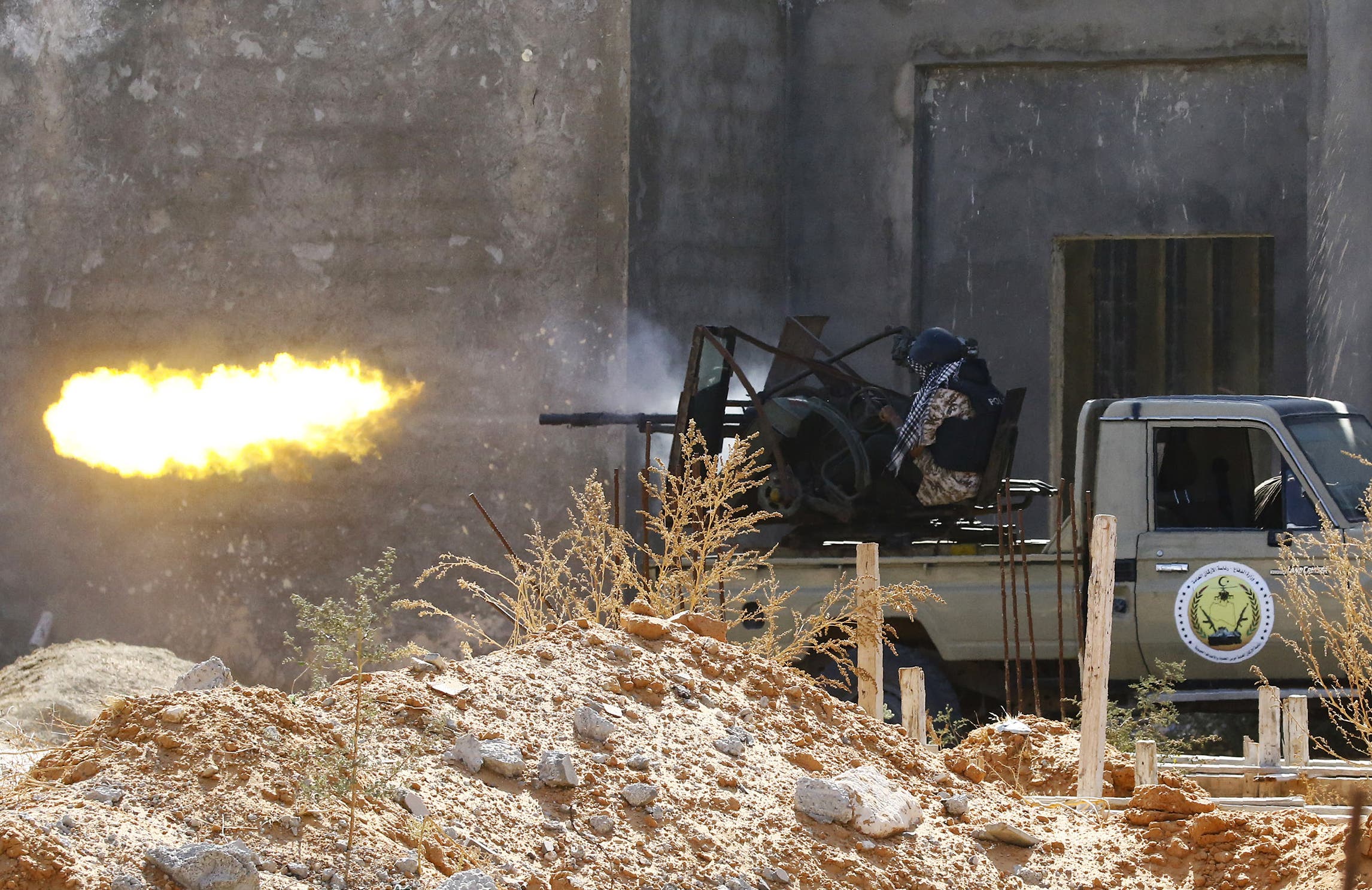 A fighter loyal to the Libyan Government of National Accord (GNA) fires a truck-mounted gun during clashes in Tripoli's suburb of Ain Zara, on September 7, 2019. (AP)