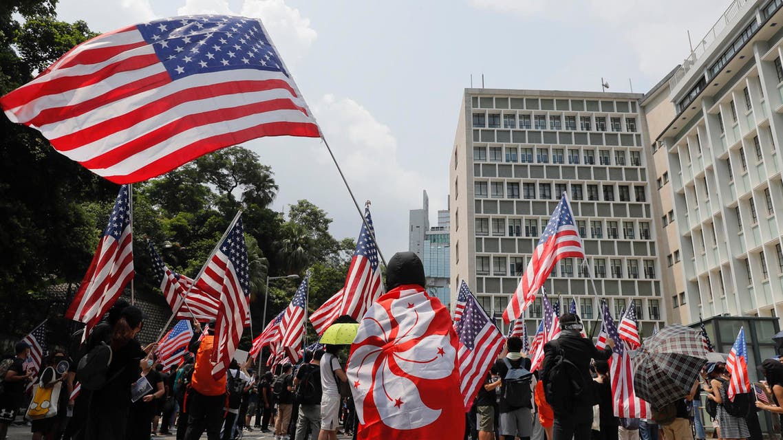 Protesters wave United States flags during a protest in Hong Kong, Sunday, Sept. 8, 2019. (AP)