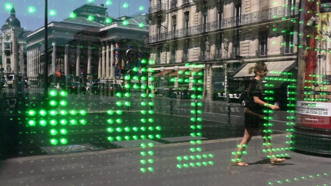 A woman walks past a window reflecting a thermometer showing a temperature of 41 degrees Celsius on July 25, 2019 in Paris. (AFP)