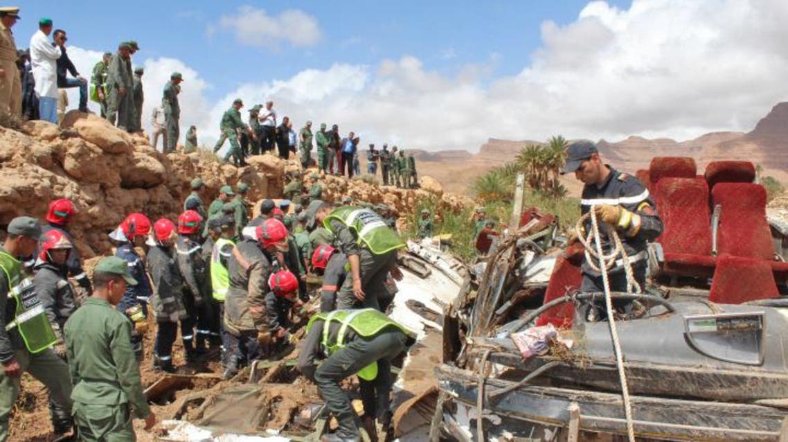 Members of the security forces search for bodies in the wreckage of bus at the banks of the Damchan river near the city of Errachidia, in the El Khank region in southern Morocco following a flood-related accident that left at least six people dead, on September 8, 2019. (AFP)