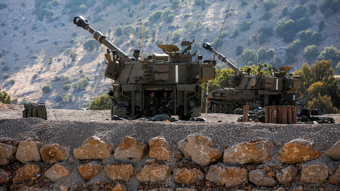 Israeli soldiers sit in the back of a self-propelled artillery gun positioned along the border with Syria in the the Israeli-annexed Golan Heights on August 25, 2019.