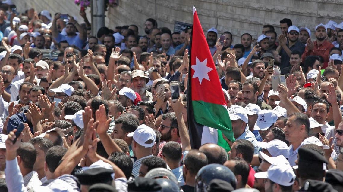 Jordanian teachers chant slogans and wave their national flag during a protest in the capital Amman. (AFP)
