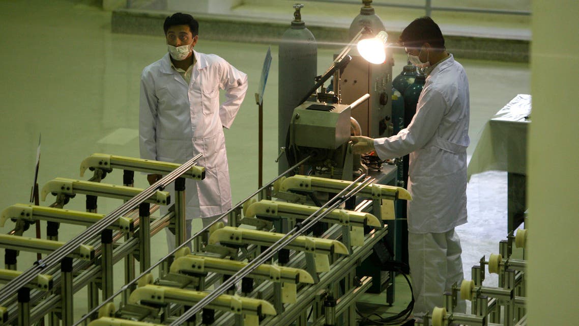 FILE - In this April 9, 2009 file picture Iranian technicians work at a new facility producing uranium fuel for a planned heavy-water nuclear reactor, just outside the city of Isfahan, 255 miles (410 kilometers) south of the capital Tehran. Iran is lagging behind on equipping a bunker with machines enriching uranium to a grade that can be turned quickly to arm nuclear warheads and now says will produce less at the site than originally planned, diplomats tell The Associated Press. The diplomats said that Iranian officials recently told the International Atomic Energy Agency that half of the approximately 1,000 centrifuges to be installed at the underground Fordow site will churn out uranium enriched to near 20 percent, while the rest will produce low-enriched material at around 3.5 percent. (AP Photo/Vahid Salemi,File)