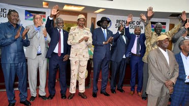Sudanese officials, rebels and diplomats react after signing the initial agreement on a roadmap for peace talks in Juba