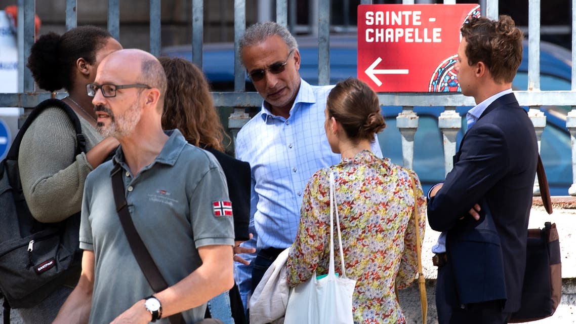 Swiss leading Islamic scholar Tariq Ramadan (C) speaks to a group of people as he leaves the Palais de Justice (Law Court) of Paris, on August 30, 2019 after a hearing. Tariq Ramadan, a leading Islamic scholar charged in France with raping two women, has also been accused of taking part in the gang rape of a journalist, French judicial sources said on August 25, 2019. The sources confirmed reports on Europe 1 radio and in Le Journal du Dimanche newspaper that a woman in her 50s had accused Ramadan, 56, of raping her along with a member of his staff when she went to interview the academic at a hotel in Lyon in May 2014.
