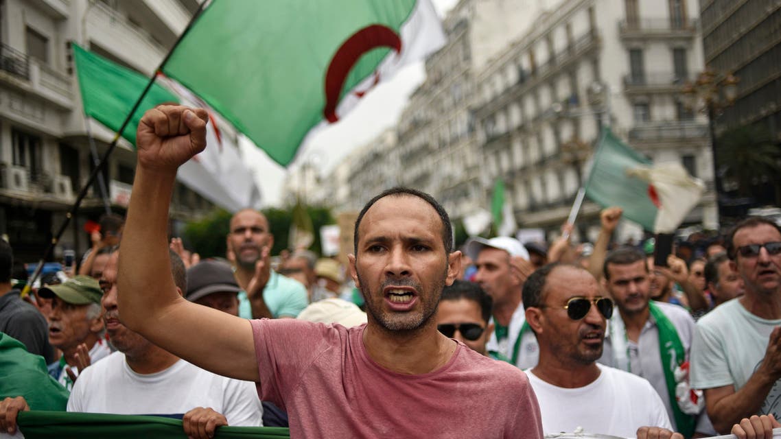 Algerian protesters wave their national flag, during a demonstration against the ruling class in the capital Algiers on September 13, 2019, for the 30th consecutive Friday since the movement began.