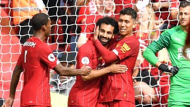 Liverpool's Egyptian midfielder Mohamed Salah (CL) celebrates with Liverpool's Brazilian midfielder Roberto Firmino (R) after scoring the team's third goal. (AFP)