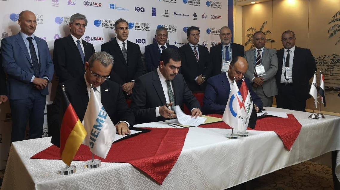 From (L to R) Karim Amin, CEO of Siemens Power Generation, Waleed Khaled Hassan, director general, general state company for electricity production north region and Orascom CEO Osama Bishai, sign a contract in the Iraqi capital Baghdad on September 14, 2019. (AFP)