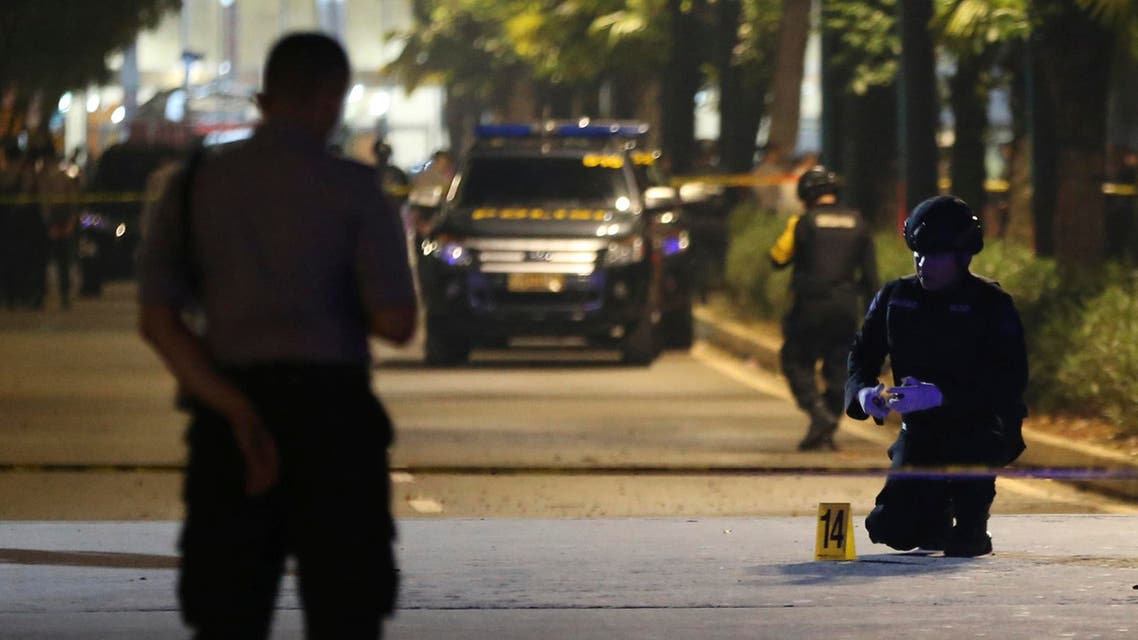 Members of bomb squad examine the site where an explosion that police said came from a firecracker, near the venue of the presidential candidates debate in Jakarta, Indonesia, Sunday, Feb. 17, 2019. (AP)