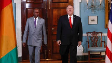 Secretary of State Mike Pompeo, right, walks with Guinean President Alpha Conde, left, at the State Department in Washington (AP)