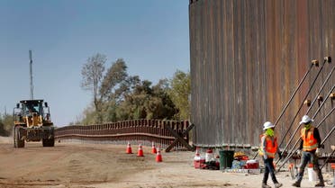 Government contractors erect a section of Pentagon-funded border wall along the Colorado River. (AP)