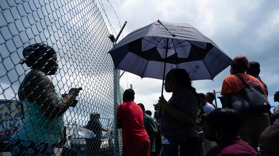 People gather at the port for aid sent by family members and friends in the aftermath of Hurricane Dorian in Freeport, Bahamas. (AP)