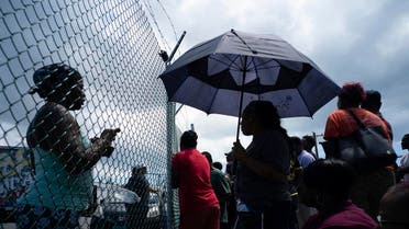 People gather at the port for aid sent by family members and friends in the aftermath of Hurricane Dorian in Freeport, Bahamas. (AP)
