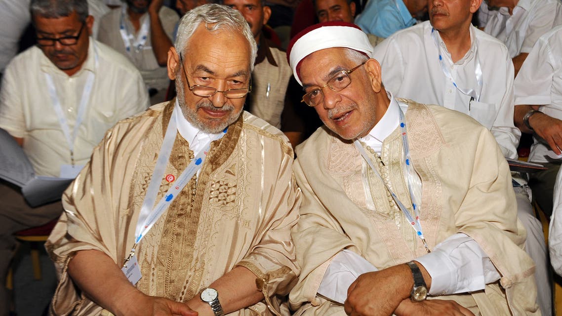 Tunisian Islamist Ennahdha Party leader Rached Ghannouchi (R) waves to the crowd with Ennahdha Party vice-president Abdelfattah Mourou on May 20, 2016 at the opening of Ennahdha's three-day congress in Tunis. Thousands of people attended the opening ceremony of the congress -- the first since 2012 -- held at a sports complex in Rades, south of the capital Tunis, amid heavy police security.
