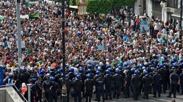Algerian security forces form a human barrier in front of demonstrators taking part in a rally in the streets of the capital Algiers on September 17, 2019. (AFP)